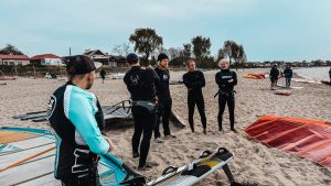 Maciek with participants on the beach