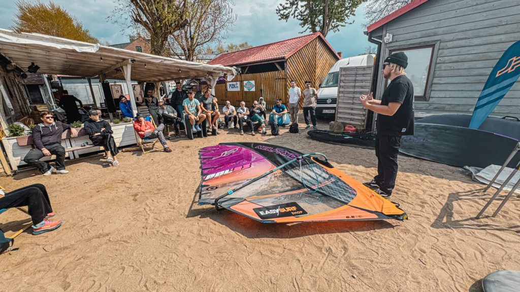 Maciek explaining how to trim a windsurfing sail