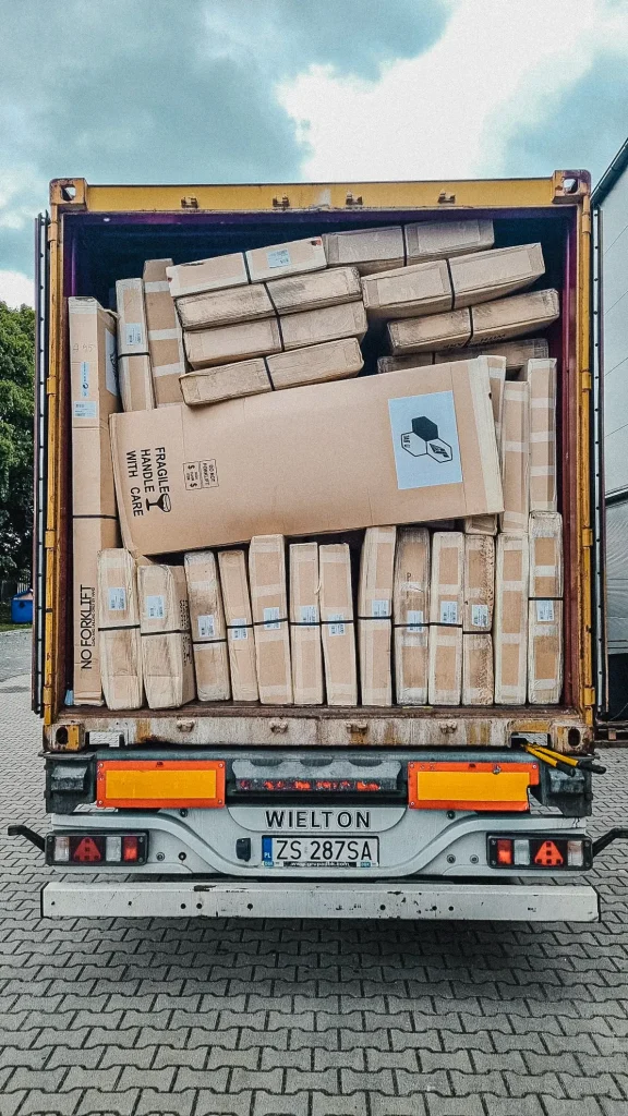 Wing and windsurfing boards in boxes in a container