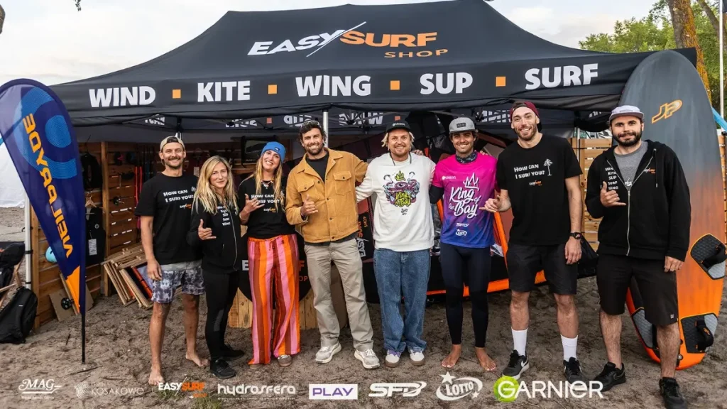 team EASY-surfshop, Matteo Iachino, Sam Steve and Maciek Rutkowski on EASY's stand at the King of the Bay watersports festival in Rewa